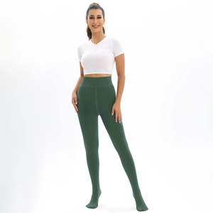 Detail view of dark green high-waisted thermal leggings with a footed design for winter