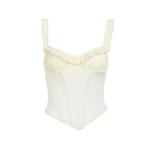 Detail of cream white ruffled corset top with structured boning and pleated fabric texture