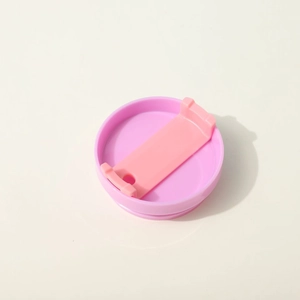 Pink portable plastic water bottle lid with a light pink slider handle, studio shot