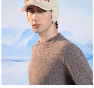 Detailed knit texture of a warm winter trapper hat with earflaps against a snowy backdrop