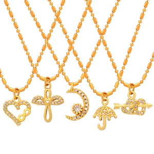 Gold beaded necklaces with moon heart and cross pendants featuring sparkling crystals