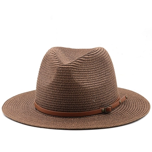 Detailed view of the woven dark brown fedora hat with a leather strap and metal buckle