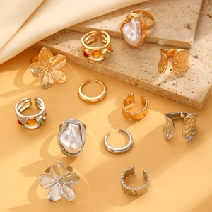 Macro view of 12pcs gold and silver lava rings with baroque pearls and flower details