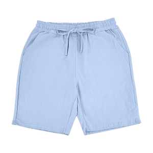 Detail view of light blue linen shorts featuring elastic waistband and adjustable drawstring