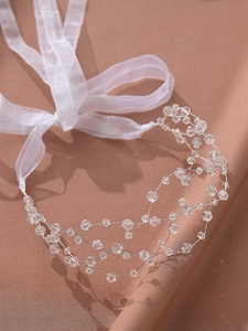Detail of beaded bridal headband with silver wire mesh and crystal embellishments