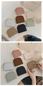 Detailed view of semi-circular PU leather coin purses in various colors with zippers
