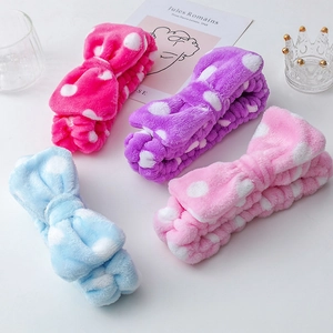 Detailed view of four colorful plush polka dot bow headbands in soft coral fleece fabric