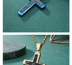 Close-up of stainless steel cross pendants with carbon fiber in blue and gold finishes