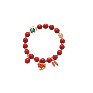 Red glass beaded bracelet with horse pendant and green faceted accents on white background