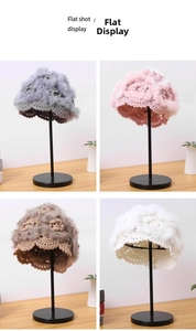 Detail of handmade crochet knit beanies in four colors with faux rabbit fur flowers