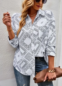 Detail of loose fit long sleeve shirt with black floral print on white hibiscus hemp fabric