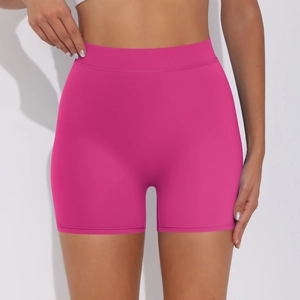 Close-up of high-waist rose red yoga shorts showing seamless elastic fabric and tummy control