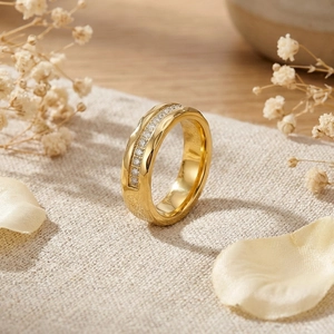 Detail of gold titanium ring with micro-pave zircon on textured fabric and wood