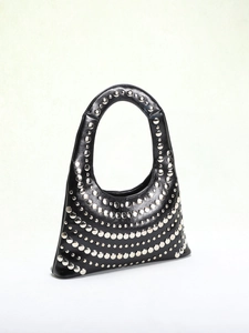 Close-up of silver rivet studs in circular rows on black leather underarm handbag