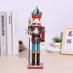 Classic wooden Nutcracker soldier with crown and spear on a purple base for home decor