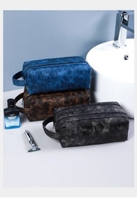 Close-up of waterproof PU leather toiletry bags in blue, brown and black for men's travel