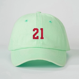Detailed close-up of a mint green cotton baseball cap featuring a bold red number 21