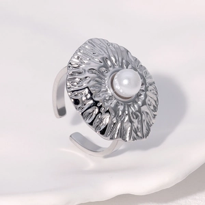Polished silver adjustable ring with textured metal setting and a central white pearl