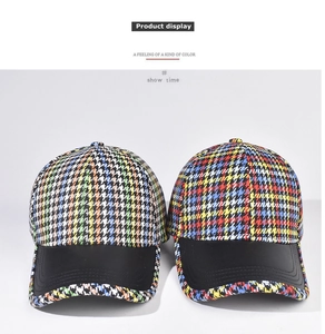 Detail of classic houndstooth baseball caps with black faux leather brim and stitching