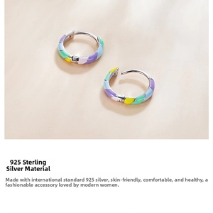 Detail of S925 sterling silver hoop earrings with colorful rainbow enamel inlay finish