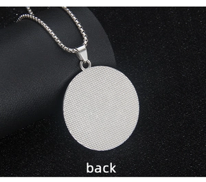 Macro view showing the textured back of a circular stainless steel pyramid necklace pendant