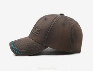 Close-up of vintage brown washed cotton baseball cap with green Mied embroidery detail