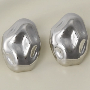 Macro detail of irregular liquid metal silver stud earrings with polished mirror finish