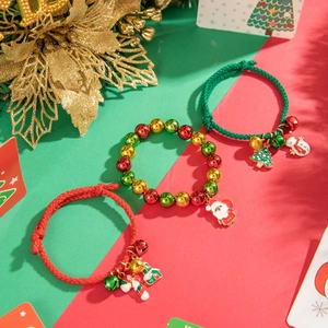 Festive Christmas bracelet details with Santa and tree charms on red braided cord
