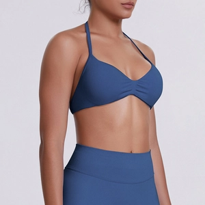 Detail of navy blue halter sports bra with center ruching and seamless high-waist yoga leggings