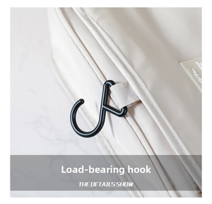 Detail showing the heavy-duty S-hook and durable travel bag stitching on beige fabric