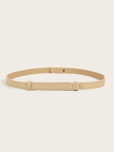Close-up of beige slim waist belt featuring cross-grain texture and metal buckle