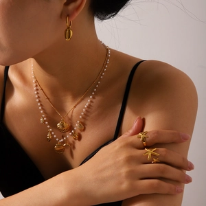 Layered 18K gold stainless steel necklace set with shell and starfish charms