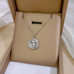Macro shot of silver stainless steel necklace with elephant seal pendant in jewelry box