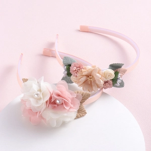 Floral headbands with pastel silk flowers and imitation pearls on a white circular base