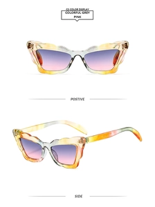 Detail view of scalloped cat-eye sunglasses with tortoiseshell frames and gradient lenses