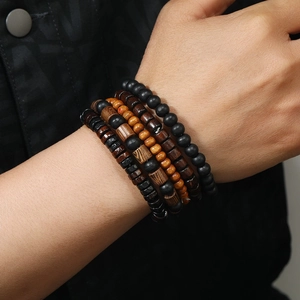 Macro view of multi-layered wooden bead bracelets with natural textures and elastic cord