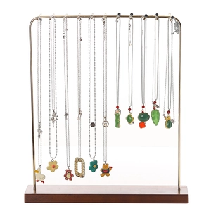 Solid wood and gold iron necklace display stand with multiple hooks on white background