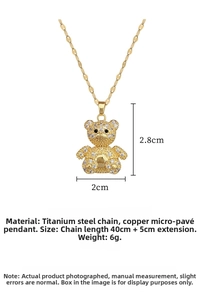 Detailed view of gold teddy bear pendant with micro-set zircons on titanium steel chain