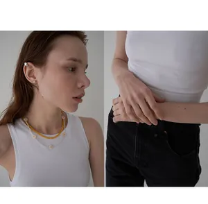 Detail view of daisy pearl necklace and elastic pearl ring set in minimalist style