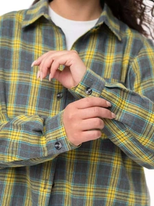 Detail of yellow and grey flannel plaid shirt cuff with black button fasteners