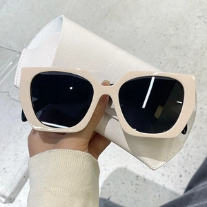 Fashionable beige oversized square sunglasses with black lenses for a stylish retro look
