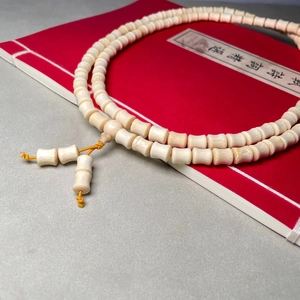 Bamboo-style dragon blood wood beads bracelet with traditional knot on red book