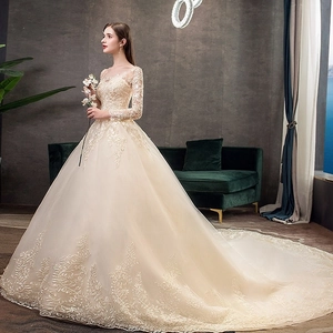 Elegante abito da sposa champagne a maniche lunghe con ricamo in pizzo e strascico