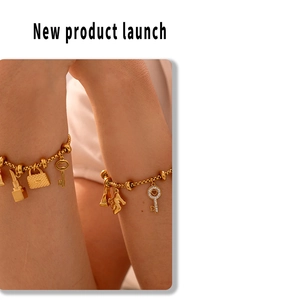 Detail of 18K gold-plated titanium steel bracelet with diamond heart and fashion charms