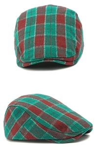 Close-up of red and green plaid flat cap fabric with thick textured wool blend material