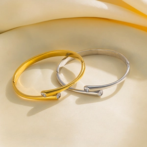 Minimalist gold and silver titanium steel bangles with sparkling zircon inlay detail