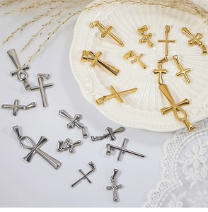 Macro shot of gold and silver cross and Ankh pendants displayed on a decorative plate