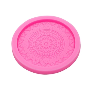 Pink silicone coaster mold featuring intricate circular mandala floral pattern carvings