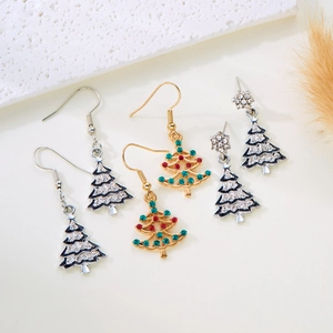 Detail of festive Christmas tree earrings with colorful crystals and rhinestones