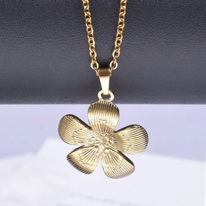 Detailed close-up of 18k gold plated flower pendant on a polished stainless steel chain